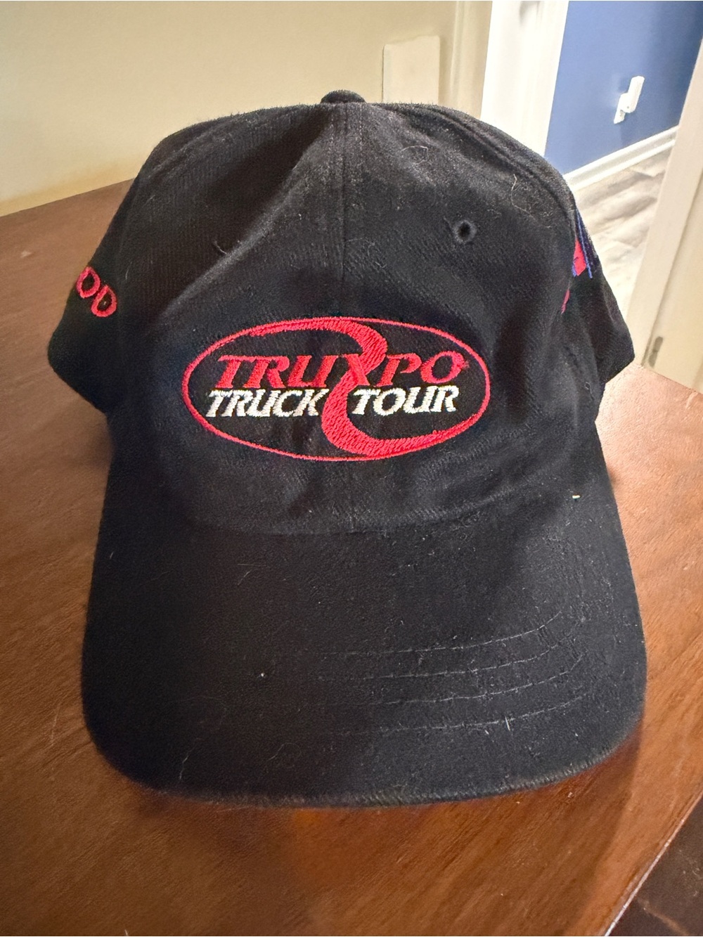 Truck Tour Black Baseball Cap with Red Logo